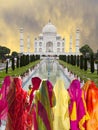 Rear viea of many indian women in saris looking at the Taj Mahal