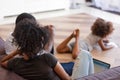 Rear view African American parents using laptop while child playing