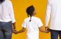 Rear view of african mother, father and daughter holding hands together Royalty Free Stock Photo