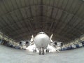 Rear view of aircraft BAe-146 in hangar for maintenance