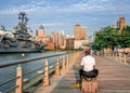 Rear view of aman at Pier 84 dock in Manhattan, with USS Intrepid. Royalty Free Stock Photo