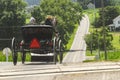 Rear View of an Amish Couple in an Open Horse and Buggy