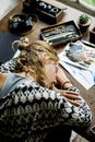 Rear view of artist woman taking a nap on work table Royalty Free Stock Photo