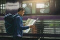 Rear view asian man holding map paper and looking router with pl Royalty Free Stock Photo