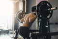 Rear view of asian man performing barbell squats at the indoor g Royalty Free Stock Photo