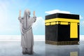 Rear view of Asian Muslim little girl in a veil standing and raised hands praying in front of the Kaaba Royalty Free Stock Photo