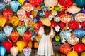 Asian traveler woman is enjoy watching lanterns in old town Hoi An, Woman choosing a lamp at Hoi An ancient town, Royalty Free Stock Photo