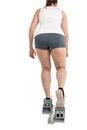 Rear view of athlete woman running from starting blocks Royalty Free Stock Photo