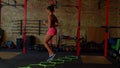 Rear view of sporty fit african female practicing agility footwork training