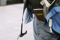 Rear view of a backpacker waiting for a train with a passport pl