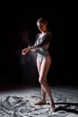 Rear view on ballet dancer woman shaking off the flour after dance perfromance Royalty Free Stock Photo