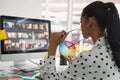 Female graphic designer working on computer at desk in office Royalty Free Stock Photo