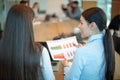 Rear view of business woman showing good statistics and graphs to her business partner at negotiations meeting in office Royalty Free Stock Photo