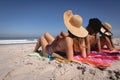 Beautiful young women lying and relaxing at beach in the sunshine Royalty Free Stock Photo