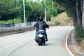 Rear view of biker driving motorcycle on the road Royalty Free Stock Photo