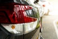 Rear view of black car in parking area. Royalty Free Stock Photo