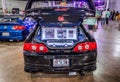 Rear view of a black Honda Integra with an open hood at Hot Import Car Show in Honolulu, Hawaii