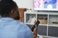 Rear view of black man watching TV Royalty Free Stock Photo