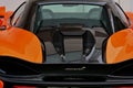 Rear view of a black and orange McLaren car