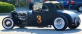 Rear View of Black 1940's Ford T-bucket antique convertible car.