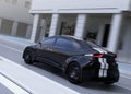 Rear view of black sports car driving on the street Royalty Free Stock Photo