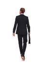 Rear view of blonde businessman walking and looking to side Royalty Free Stock Photo