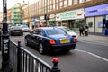 Rear view of blue luxury Rolls-Royce car driving on Kentish Town Rd Royalty Free Stock Photo