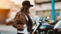 Rear View of a Bold and Assured Female Biker, Standing Proudly by Her Parked Motorcycle. Generative AI