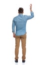 Rear view of a bothered casual man arguing and gesturing