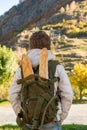 Rear view of boy with backpack in autumn mountains Royalty Free Stock Photo