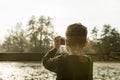 Boy photographing nature with a compact camera Royalty Free Stock Photo