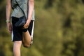 Rear view of a boy stretching his leg warming up for a soccer practice