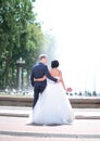 Rear view.bride groom looking at the fountain