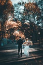 Rear view of a bride and groom on wedding day walking in the Central Park of New York City Royalty Free Stock Photo