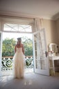 Rear view of bride standing at doorway at home Royalty Free Stock Photo