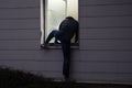 Burglar Entering House Through Window Royalty Free Stock Photo