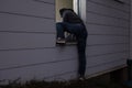 Burglar Entering House Through Window Royalty Free Stock Photo