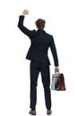 Rear view businessman celebrating and holding briefcase Royalty Free Stock Photo