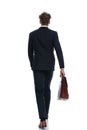 Rear view businessman holding his briefcase and walking Royalty Free Stock Photo