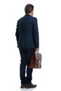 Rear view of a businessman holding his suitcase Royalty Free Stock Photo
