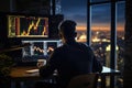 Rear view of businessman sitting in front of computer monitor with stock market data and looking at city at night