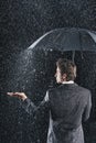 Rear View Of Businessman Under Umbrella Royalty Free Stock Photo