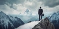 Rear view of businessman wearing formal suit and holding suitcase, standing on the mountain peak while looking at sky. Royalty Free Stock Photo