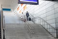 Rear view of businesspeople with luggage moving upstairs in railroad station