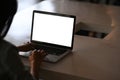 Businesswoman concentrate working on laptop computer while sitting in dark office room.