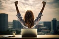 Rear view of businesswoman sitting at table with laptop and raising arms at sunset, Excited girl sitting at her desk with a laptop