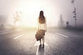 Rear view of businesswoman walking on misty road