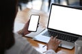 Businesswoman working with computer laptop and using mobile phone in modern office. Royalty Free Stock Photo