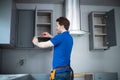 Rear View Of Carpenter Installing Luxury Modern Fitted Kitchen Royalty Free Stock Photo