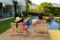 Happy young couple relaxing near the swimming pool Royalty Free Stock Photo